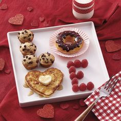 valentine's day breakfast with heart shaped pancakes, raspberries and chocolate chip muffins