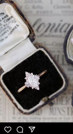 an open box with a diamond ring in it