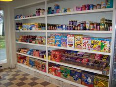 a store filled with lots of different types of food on shelves next to a glass door