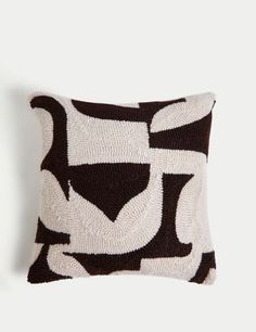 a black and white pillow sitting on top of a wall