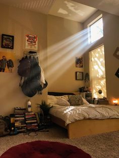 a bed room with a neatly made bed and sunlight streaming through the window over it