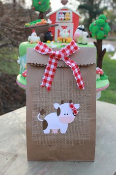 a brown bag with a cow on it sitting on top of a wooden table outside