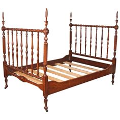 a wooden bed frame with two posts and no headboard or foot board is shown