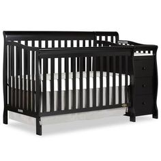 a black crib with white sheets on the bottom and side rails, next to a night stand