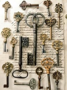 an assortment of antique keys are displayed on a piece of paper