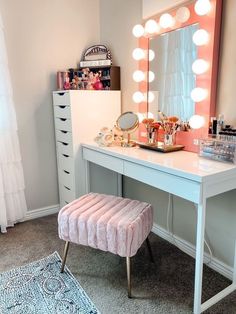 a vanity with a stool, mirror and lights on it