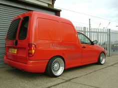 an orange van parked in front of a garage door with the word maceberry written on it