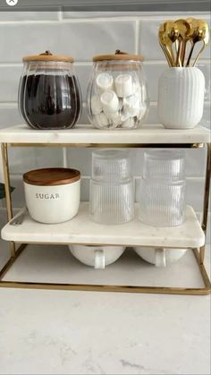 three tiered shelving unit with glass jars and bowls