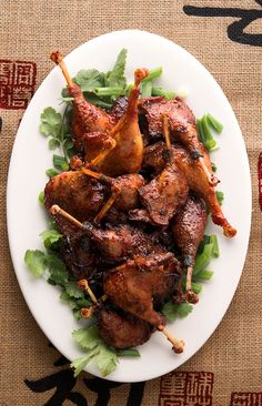 chicken skewers with cilantro and parsley on a white plate