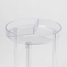 clear acrylic side table with three sections on one end and two legs on the other