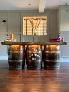 three wooden barrels sitting on top of a hard wood floor