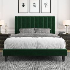 a bed with green velvet headboard and foot board in a white walled bedroom area