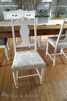 a dining room table and chairs with white painted furniture