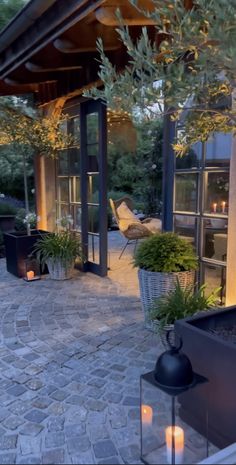 an outdoor living area with potted plants and candles