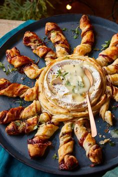 a platter filled with croissants and dip