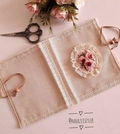 a pair of scissors sitting on top of a table next to a lace doily