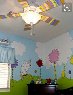 a child's bedroom with dr seuss and the cat in the hat mural