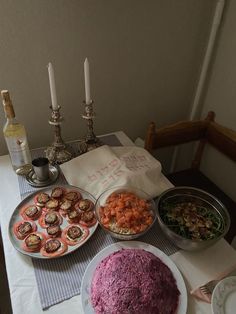 a table topped with plates and bowls filled with food