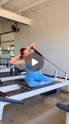 a woman is doing pivots on a rowing machine