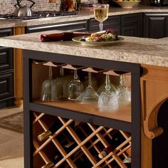 a kitchen island with wine glasses on it