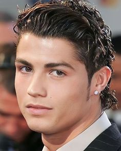 a close up of a person wearing a suit and tie with water on his head