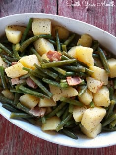 a white bowl filled with potatoes and green beans