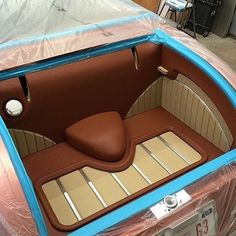 the inside of a car is covered in plastic and it's seats are brown