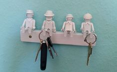 several lego figures are hanging on a key rack