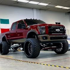 a large red truck parked in a garage