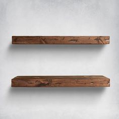 two wooden shelves are hanging on the wall