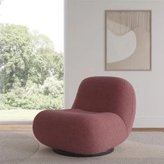 a living room with a pink chair and white rug in front of a large window