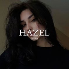 a woman with long black hair and the words hazel leader on her face in front of her