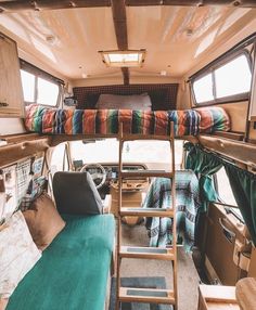 the inside of a camper with bunk beds and ladders on each side,