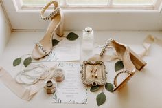 wedding shoes and jewelry on display in front of window