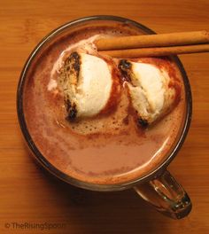 homemade spicy hot cocoa with cacoa powder and cinnamon sticks in a metal mug