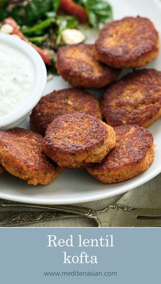 red lentil kofta on a white plate with salad and ranch dressing in the background