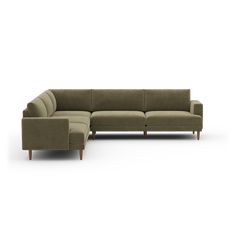 a large sectional couch sitting on top of a white floor next to a footstool