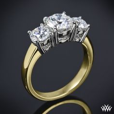 three stone diamond ring on black background