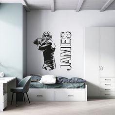 a bedroom with a football player wall decal on the wall next to a bed