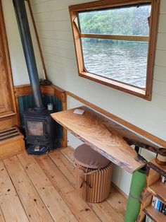 there is a wood stove in the corner of this room with wooden floors and walls