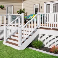 a white deck with steps leading up to a house