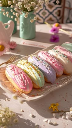 there are many decorated cookies on the plate with sprinkles and frosting