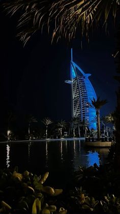 the burj building is lit up at night