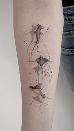 a woman's leg with an abstract tattoo design on the side of her thigh