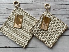 two woven placemats with tags on them