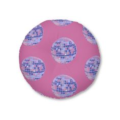 a pink and blue round pillow with disco balls on the front, against a white background