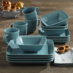 a table topped with blue dishes and cups