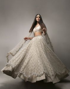 Antique Gold Blouse with hints of pink and turquoise teamed with a burnt orange mirror work skirt with gold border; and a red dupatta with gold border work and scattered buttis Double Layer Skirt Indian, White Ivory Lehenga, Full White Lehenga, Gold And Silver Lehenga, Manish Malothra Lehenga, Ivory Colour Lehenga, Lehenga For Indian Wedding, Two Layer Lehenga, Ivory Lehnga Designs