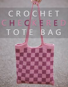 the crochet checkered tote bag is being held by a woman's hand