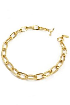 Streamlined, dimensional and sleek, this 14K gold plated brass chain was designed to make a statement solo or layered. Hand-cast and hand-polished to perfection in Canada, the custom-crafted oval links are designed to catch the light casting constant movement and their weight is balanced and light. The toggle can be used anywhere along the chain to create a shorter, choker silhouette or a lariat style. Each link is crafted one-by-one and assembled by hand to create the perfect go-to necklace. It is an elevated classic piece you'll come back to for years and years. Styling tip: wear it as a streamlined chain with clasp to the back, or turn the toggle detail to the front to showcase as a centerpiece. 14k gold plating, Brass Chain Length is 18" Link is 1/2" W x 3/4" L x 1/8" D Toggle Clasp Hy Gold Collar Necklace, Spring Jewelry, Gold Collar, Pearl Collection, Gear Bag, Hand Cast, Jewelry Tools, Scarf Jewelry, Wallet Bag